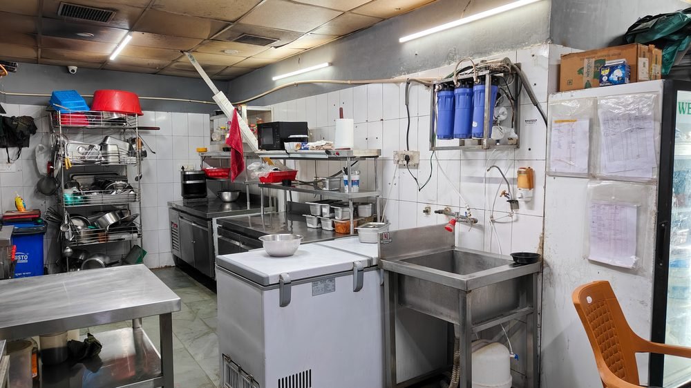 Prep stations, stainless tables and storage in a Blue Wings kitchen for rent, Chandigarh