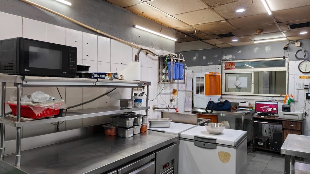Bright, tidy prep kitchen with stainless tables and storage